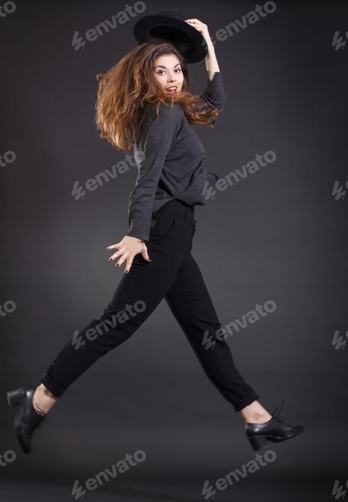 Preview: Fashionable Girl In A Jump On A Dark Background.
