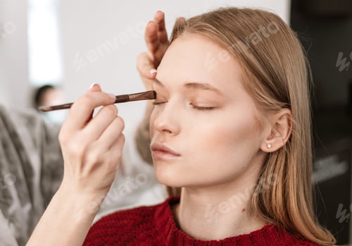 Preview: Makeup Artist Applies Eye Shadow To The Eyelids On A Beautiful Young Woman Blonde Model, Face Make