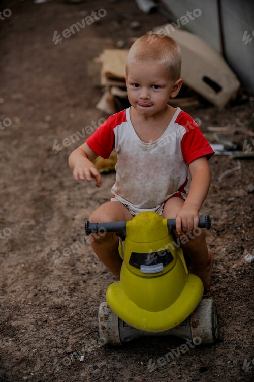 Preview: Rustic Boy In T-Shirt Play In Farmyard On Background Of Sunset. Child Is Happy In Village On
