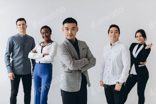 Preview: Cheerful Multiracial Professional Business People Laughing Together Standing In Row Near Wall