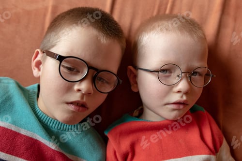 Preview: Two Brothers In Bright Colored Clothes Posing In Front Of Camera With Glasses For Vision. Children