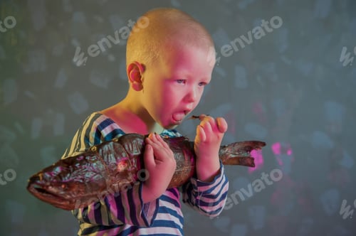 Preview: Little Blond Boy Shows Big Smoked Fish. Child Wants To Catch Big Fish In River. Concept Of Organic