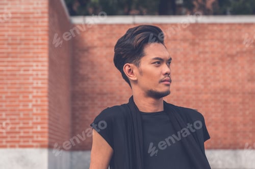 Preview: Young Handsome Asian Model Dressed In Black Tunic Posing In The City Streets
