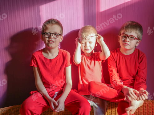 Preview: Funny Children In Red Clothes Posing In Front Of Camera. Boys Actively Express Their Emotions