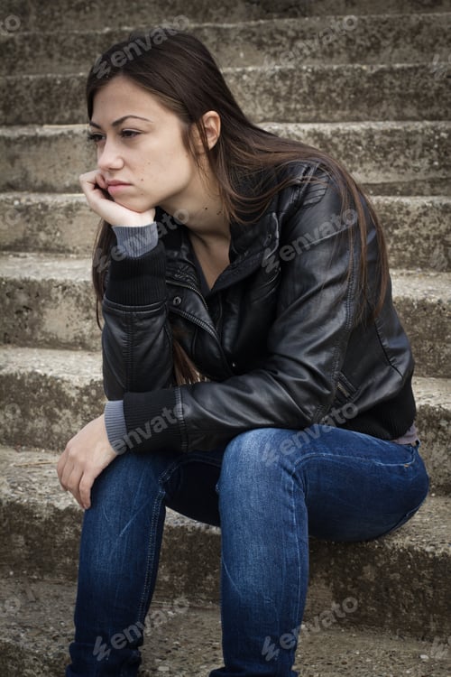 Preview: Portrait Of Depressed Teenage Girl Sitting On Staircase.