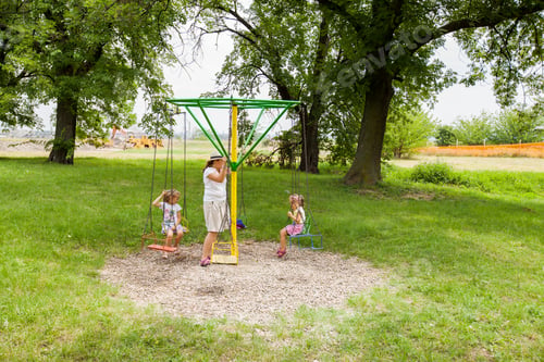 Preview: Mother And Daughters Have Fun In Summer Park At Carousel Swing