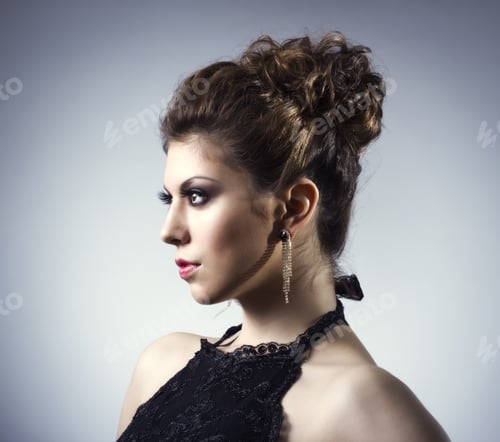 Preview: Elegant Woman Posing with Dark Curly Hair