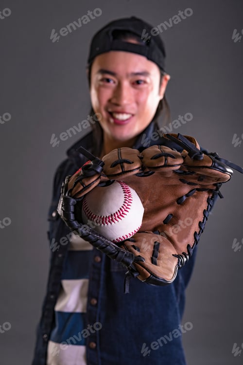 Preview: Asian Professional Baseball Player In Action. Isolated On Black Background.