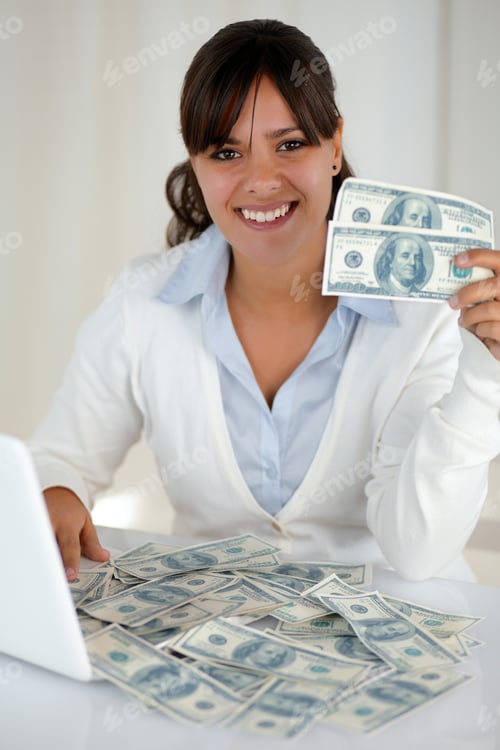 Preview: Portrait Of A Young Woman Looking And Smiling At You Sitting In Front Of Her Laptop With Plenty Of
