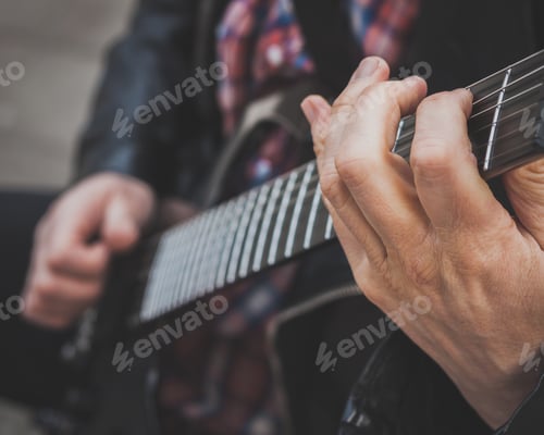 Preview: Detail Of Male Fingers Playing Electric Guitar