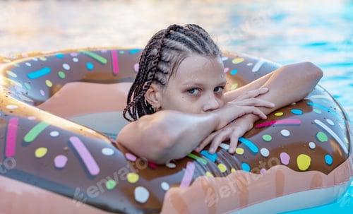 Preview: Girl Swimming In The Pool On An Inflatable Donut