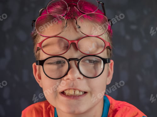 Preview: Photo Of Funny Kid With Many Pairs Of Glasses On Face