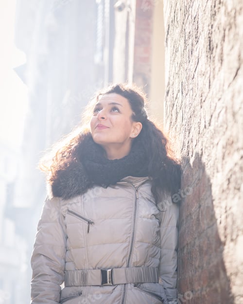 Preview: Beautiful Young Brunette With Long Curly Hair Posing In The City Streets
