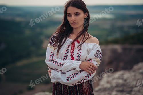 Preview: Attractive Woman In Traditional Romanian Costume On Mountain Green Blurred Background. Outdoor