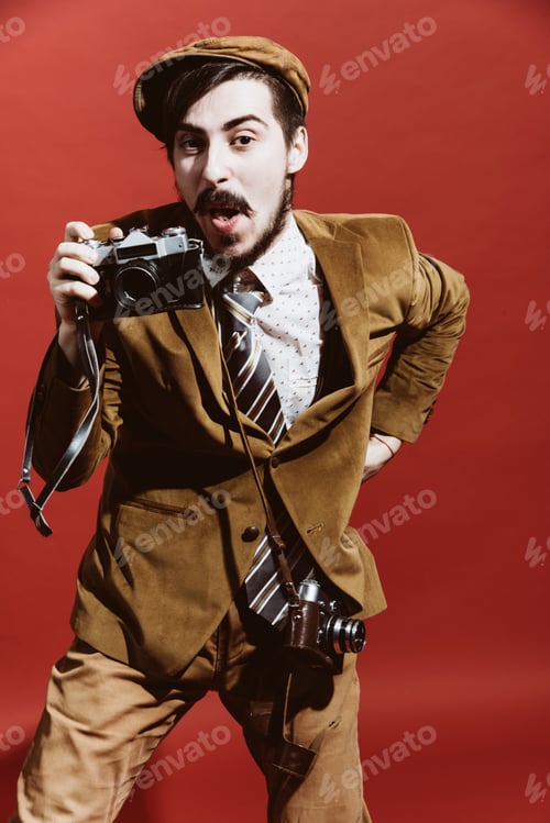 Preview: Very Positive Photographer Posing In Studio With Camera