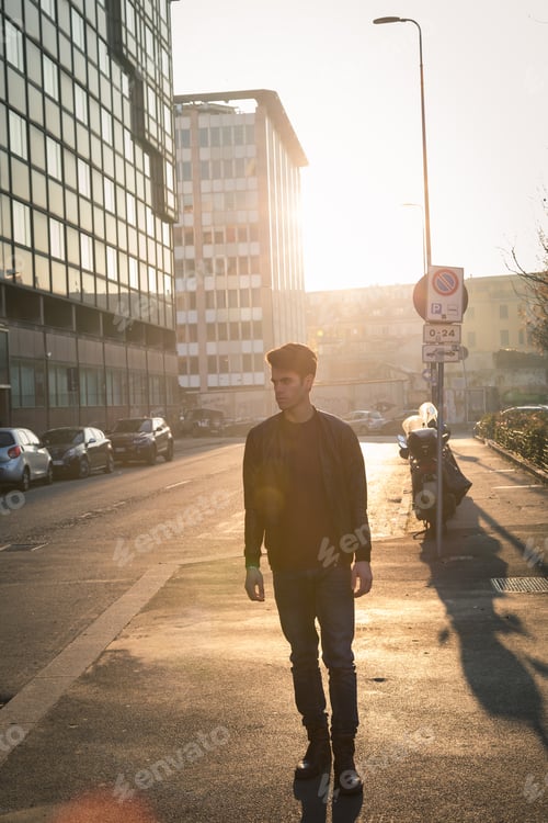 Preview: Beautiful Young Man With Short Hair Posing In An Urban Context. Backlight.