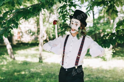 Preview: Emotional Male Mime Artist With Red Rose Performing Love On A Outdoor.
