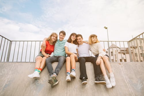 Preview: Summer Holidays And Teenage Concept - Group Of Smiling Teenagers Hanging Out Outside.