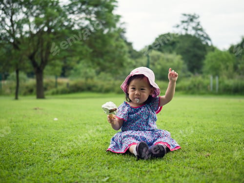 Preview: Baby Girl Eating Icecream In Summer Garden