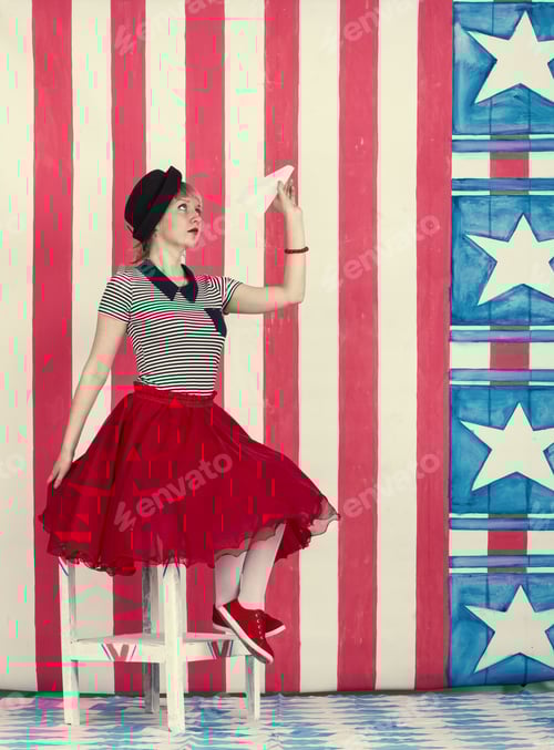 Preview: Playful Woman in Red Skirt with Paper Airplane