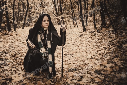 Preview: Charming Lady With Dreadlocks Wearing Black Mantle Standing By The Old Tree In The Autumn Forest