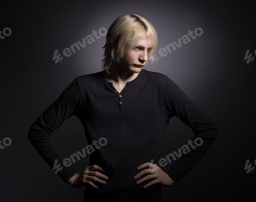 Preview: Portrait Of A Young Stylish Man With White Hair On A Black Background.
