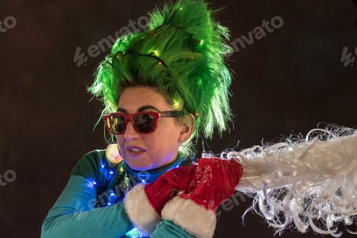 Preview: Splendid Girl With Green Hair Dressed In Christmas Garlands. A Girl Is Depicting A Christmas Tree