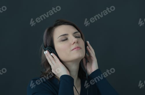 Preview: Portrait Of A Young Beautiful Girl On A Black Background With Headphones
