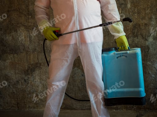 Preview: Elderly Man In Protective Overalls, Special Glasses And Bactericidal Mask With Blue Electric Spray