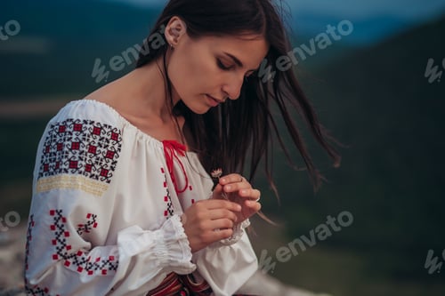 Preview: Attractive Woman In Traditional Romanian Costume On Mountain Green Blurred Background. Outdoor