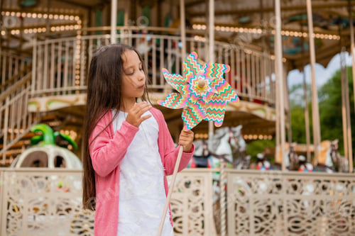 Preview: Cute Teen Girl Plays Near Carousel In Toy Breeze