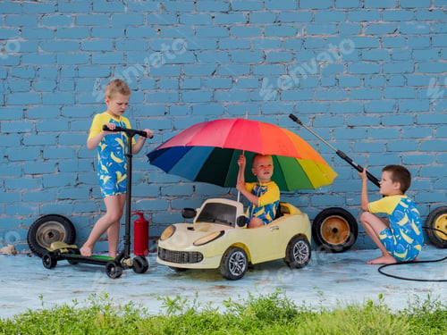 Preview: Funny Children In Boys' Bathing Suits Posing In Front Of Camera With High-Pressure Car Wash And Toy