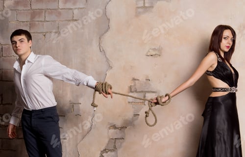 Preview: Conceptual Shot Of Man And Woman Pulling A Rope