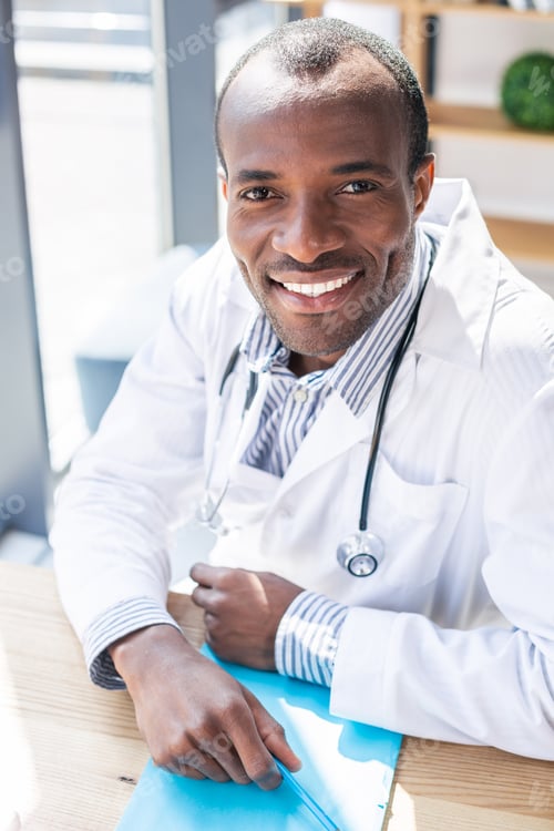 Preview: Joyful Lifestyle. Delighted Brunette Leaning On Table While Being In Medical Uniform