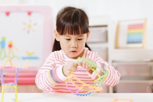 Preview: Young Girl Playing Creative 3D Shape Toy For Homeschooling