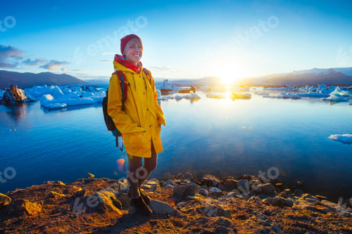 Preview: Woman In Bright Yellow Raincoat Near The Glacier Lagoon, Iceland