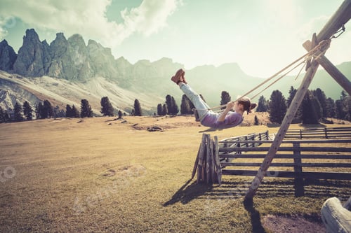 Preview: Happy Fun Life. Girl Swinging On A Swing In The Park Puez Odle. Italy