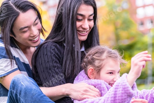 Preview: Happy Family Hugging In A Park