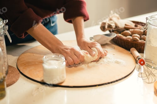 Preview: Close Up Of The Wooden Cutting Board And Hands Of Woman Kneading Dough On It