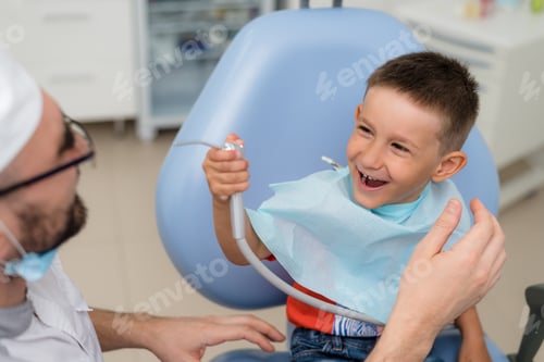 Preview: Doctor Orthodontist Playing With The Boy In The Dental Office.