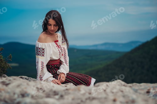 Preview: Attractive Woman In Traditional Romanian Costume On Mountain Green Blurred Background. Outdoor
