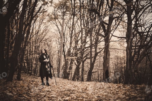 Preview: Charming Lady With Dreadlocks Wearing Black Mantle Standing By The Old Tree In The Autumn Forest
