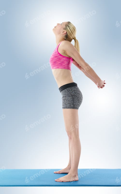 Preview: Young Blond Haired Woman Performing Yoga On Blue Exercise Mat.