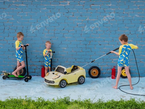 Preview: Funny Children In Boys' Bathing Suits Posing In Front Of Camera With High-Pressure Car Wash And Toy