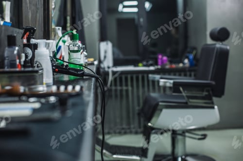 Preview: Horizontal Image Of A Dark Barbershop With Barbers Chair And Necessary Equipment On The Table