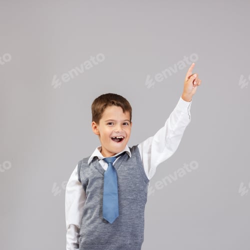 Preview: A Small Boy Of School Age With A Raised Index Finger.