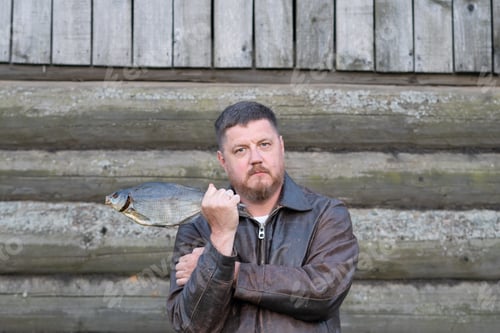 Preview: Portrait Of A Man Holding Dried Fish