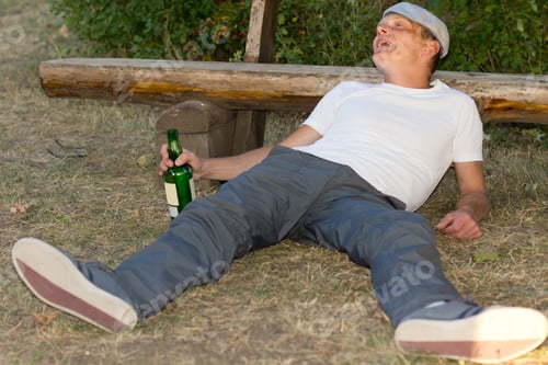 Preview: Drunk Caucasian Adult Man Lying Down On The Ground Experiencing Euphoria After Excessive Drinking