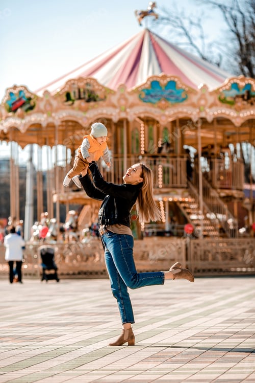 Preview: Stylish Young Mom Walks With The Baby In The Park. Happy Mom