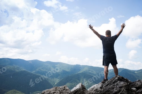 Preview: Man Standing At The Edge Of Rock